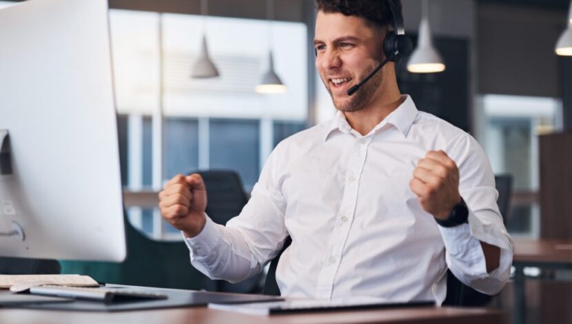 Man, call center and celebration for winning, sale or promotion in customer support or service at o